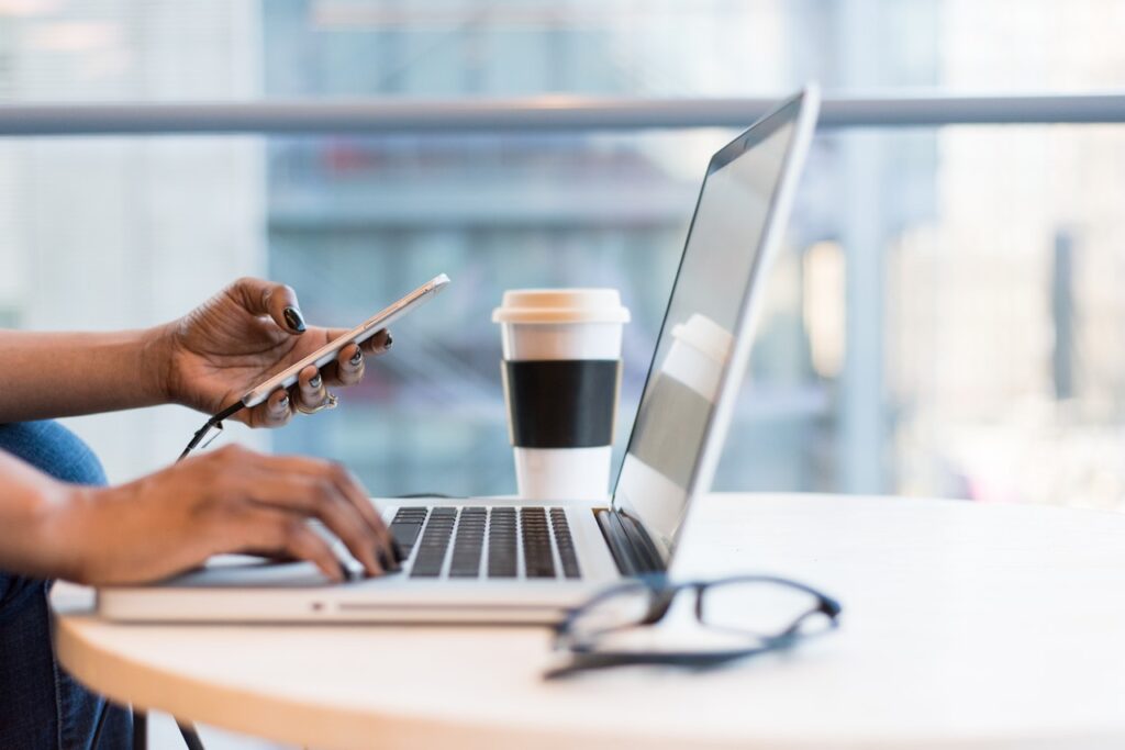 person using macbook air on table